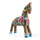 A dun horse with a scattering of flowers