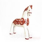 A snow-white horse with a red pattern