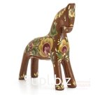 A dun horse with a yellow flower on its side